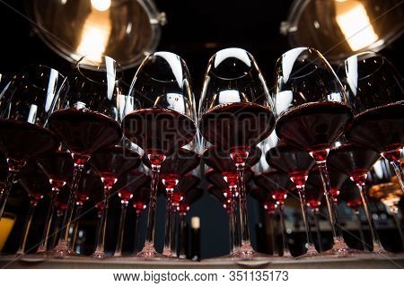 Glasses Of Red Wine Are On The Table, Ready To Serve.