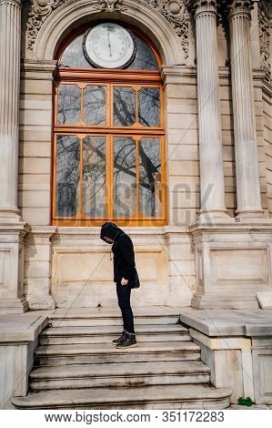 Teen In Glasses And Black Clothes Standing On The Steps Of An Old Building In Istanbul