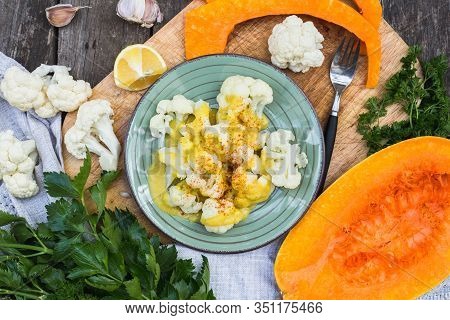 Steamed Cauliflower With Sauce And Pumpkin On Table.