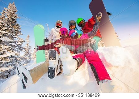 Group Of Happy Friends Having Fun In Winter Forest. Snowbarders And Skiers Group Team Friendship Ski