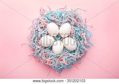 Easter Creative Composition. Flat Lay With Easter Egg And Kraft Paper Pink And Blue Filler On Pink B