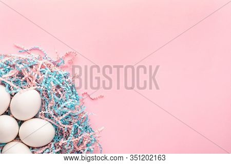 Easter Creative Composition. Flat Lay With Easter Egg And Kraft Paper Pink And Blue Filler On Pink B