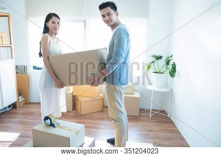Asian Couple Receive Shipment From Delivery Man, Order Box Shipping From Online Store Website To Del