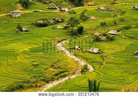 Photograph Of A Vietnamese Village In A Valley Surrounded By Rice Paddies And Crossed By A River