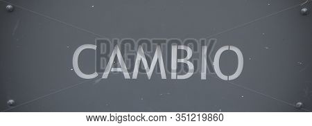 It Says Cambio In White On Gray Background.