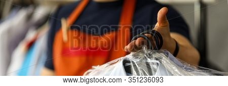 Clothes Dry Cleaning Service Worker Returning Shirts To Customer Close-up