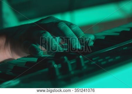Hand Of A Pianist Or Keyboardist Of A Rock Band Close Up Playing A Synthesizer. Selective Focus