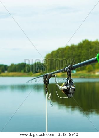 Carp Fishing On Beautiful Blue Lake With Carp Rods And Rod Pods In The Summer Morning. Fishing From 