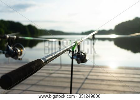 Carp Fishing On Beautiful Blue Lake With Carp Rods And Rod Pods In The Summer Morning. Fishing From 