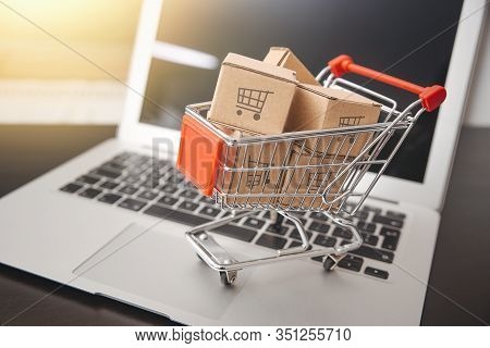 E-commerce, Shopping Trolley With Paper Boxes. Trade, Selling Via Internet