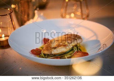 Delicious Fillet Of Grilled And Oven Baked Codfish Or Coalfish Served With Thin Sliced Vegetables An