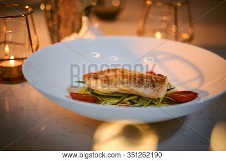 Delicious Fillet Of Grilled And Oven Baked Codfish Or Coalfish Served With Thin Sliced Vegetables An