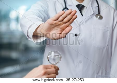 The Concept Of Stop Alcohol. Doctor Shows Gesture Prohibiting The Use Of Alcohol.