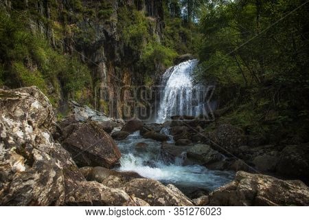 Korbu Waterfall at Lake Teletskoye in the Altai Mountains. The most famous lake waterfall