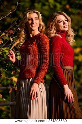 Freedom. Girl Friends Walk In Park. Sunny Day With Fallen Leaves. Fall Fashion Season. Pleated Trend