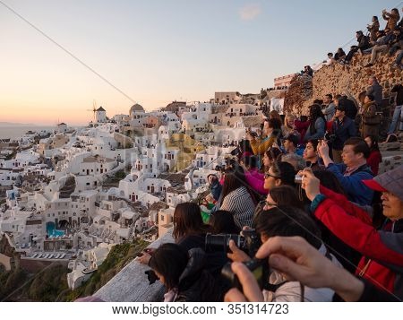 People Watch The Sunset In Oia, Santorini, Greece