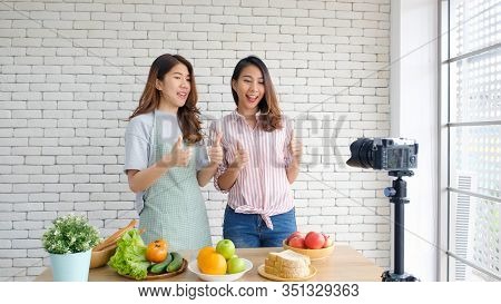 Two Young Asian Food Blogger Recording Cooking Tutorial, Asia Girls Vlogger Thumb Up And Looking At 