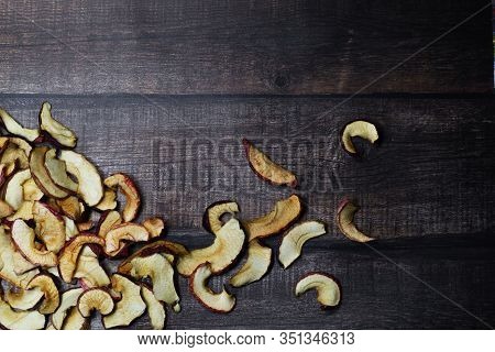 Dried Apple Chips On A Brown Wooden Table. Organic Natural Food. Top View. Flat Lay.
