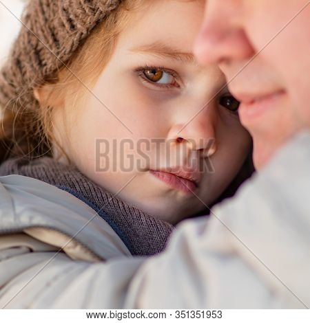 A Daughter In A Hat Is Lying In Her Father Arms In Winter Clothes Love In The Family.