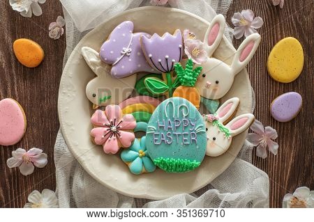 Happy Easter. Multi-colored Pastel Easter Cookies On A Wooden Background. Easter Concept