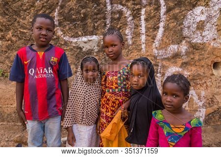 Bissau, Guinea-Bissau - January 5, 2020: group of African Kids looking at the camera in rural Guinea-Bissau