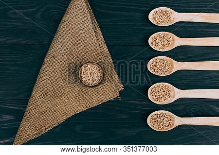 Wheat Harvest. Dry Ripe Wheat Grains On Wooden Background