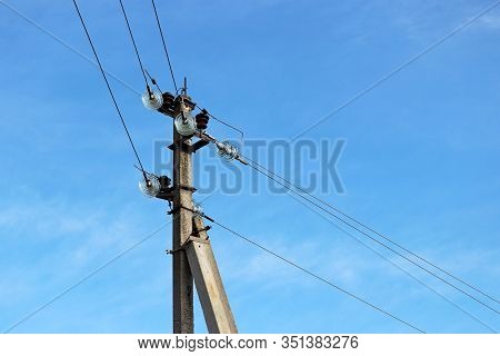 Power Line Post With Electrical Wires And Capacitors Isolated On Blue Sky Background. Electricity Tr