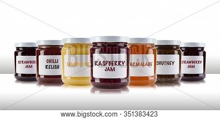 A Group Jars Containing Jams And Preserves, Including Rasperry, Strawberry, Marmalade, Chutney And R