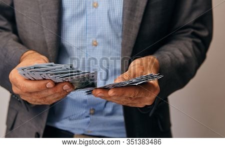 A Closeup Of Hands Of A Man Who Remits Money