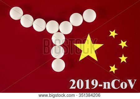 Bacterial Cell Made Of White Tablets With The Inscription 2019- Ncov On A Red Background Of The Chin
