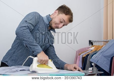 A Man Of About 30 Years Irons His Clothes With An Iron, Leads A Bachelor Lifestyle, Is Going To Visi