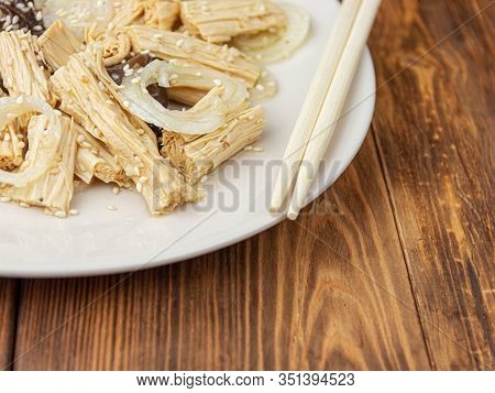 Close-up Spicy Chinese Or Korean Yuba Tofu Bamboo And Oyster Mushrooms On Wooden Background.