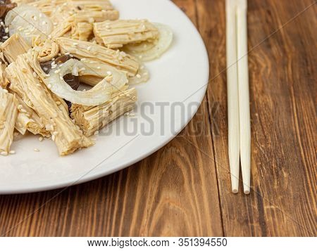 Close-up Spicy Chinese Or Korean Yuba Tofu Bamboo And Oyster Mushrooms On Wooden Background.