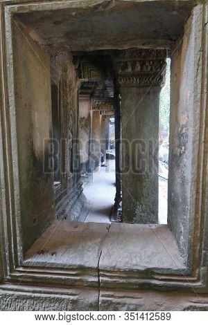 Looking Through A Window At Stone Pillar In Famous Histroical Angkor Wat Ruins, Cambodia