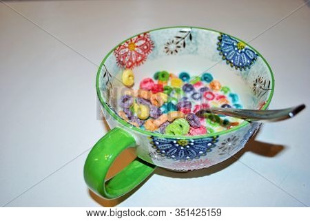Close Up Of A Bowl Full Of Fruit Flavored Loops Of Sugar Ready To Eat Breakfast Cereal With A Spoon