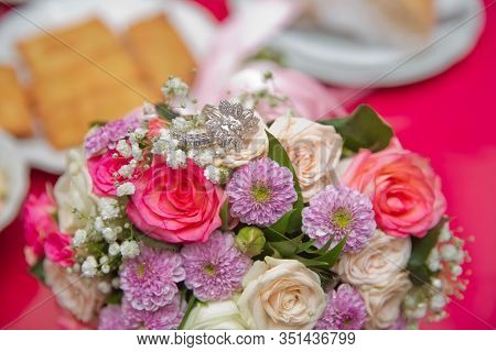 Close Up Wedding Ring On Top Of A Colorfull Bouquet. . Macro .close Up Of Wedding Rings On The Bouqu