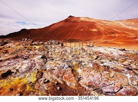 Boiling mud pools in a geothermal landscape in Iceland