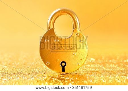Word Success Written On The Golden Padlock With Gold Background. Way To Wealth And Success Idea.