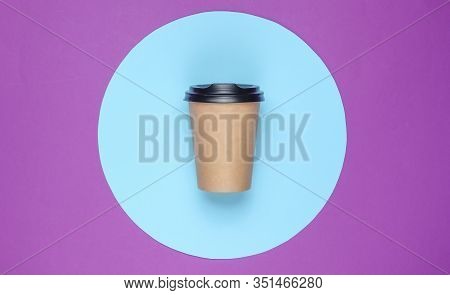 Сraft сardboard сoffee сup On Purple Background With Blue Pastel Circle. Top View