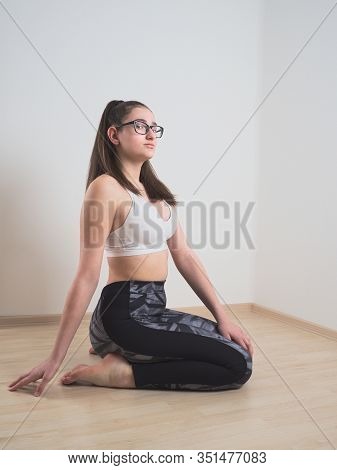 Young Bespectacled Teen Girl Posing In Sportswear