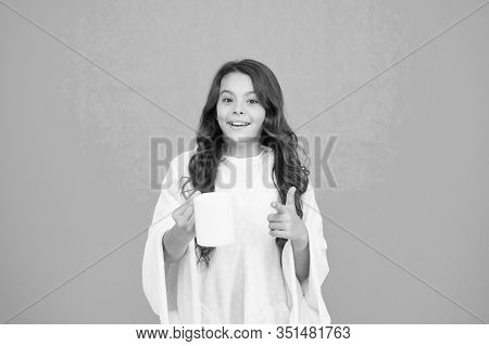 Kid Wearing Soft Poncho Drinking Tea. Little Girl With Long Hair. Feeling Comfy. Adorable Child On T