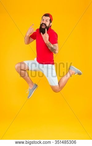 Excited Bearded Man Jumping. Full Of Energy. Impetuous Movement. Dedicated To Sport And Fitness. Act