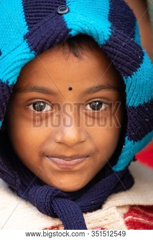 RAGHURAJPUR, INDIA, JANUARY 14, 2019 : Close portrait of a serious Indian little girl .