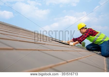 Construction Worker Install Roof Repair, Fixing Roof Tiles On House With Blue Sky In Safety Kits For