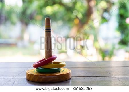 Quoits, Wooden Toy On Wooden Texture In Bokeh Garden Background, Selective Focus, Close Up Shot, Gam