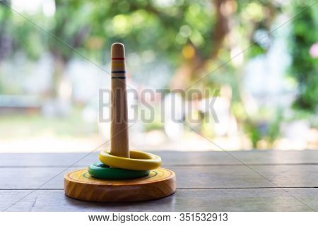 Quoits, Wooden Toy On Wooden Texture In Bokeh Garden Background, Selective Focus, Close Up Shot, Gam