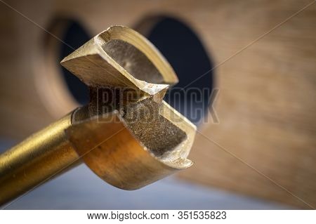 Close Up Forstner Bit For Drilling Circular Holes On Top Of Wooden Block
