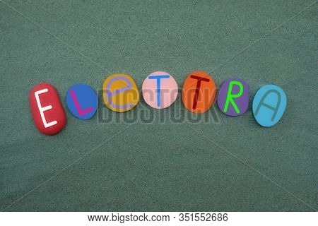 Elettra, Female Name Composed With Multi Colored Stone Letters Over Green Sand
