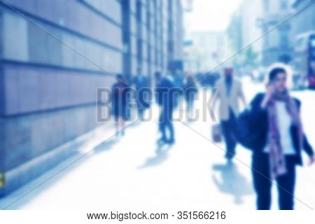 blurred people walking o the street