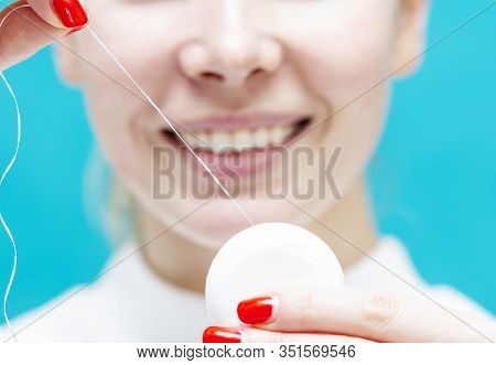 Man Holds Dental Floss On The Background Of A Beautiful Smile, Dental Care